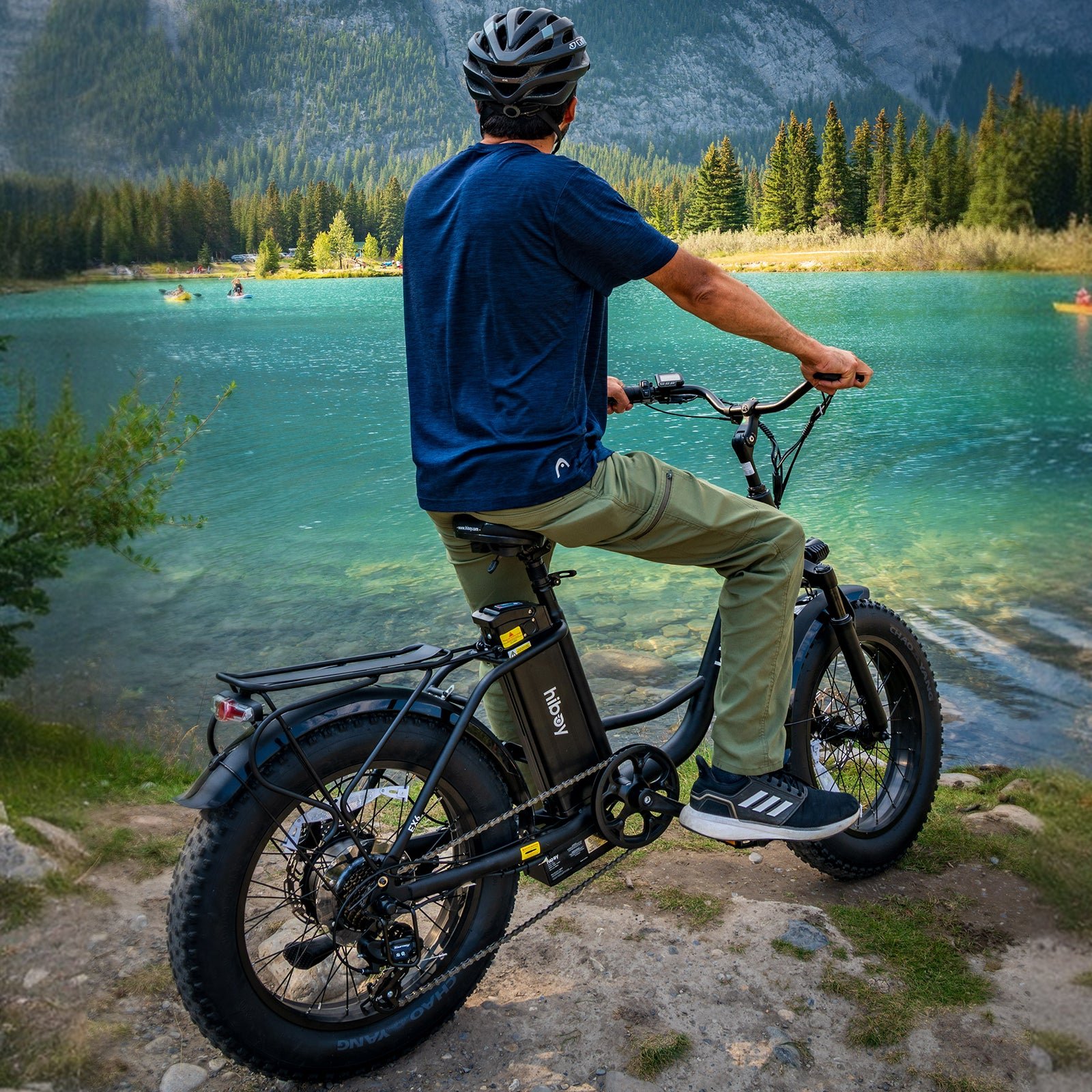 Rider on the Hiboy EX6 step-through fat tire electric bike looking out over a turquoise mountain lake