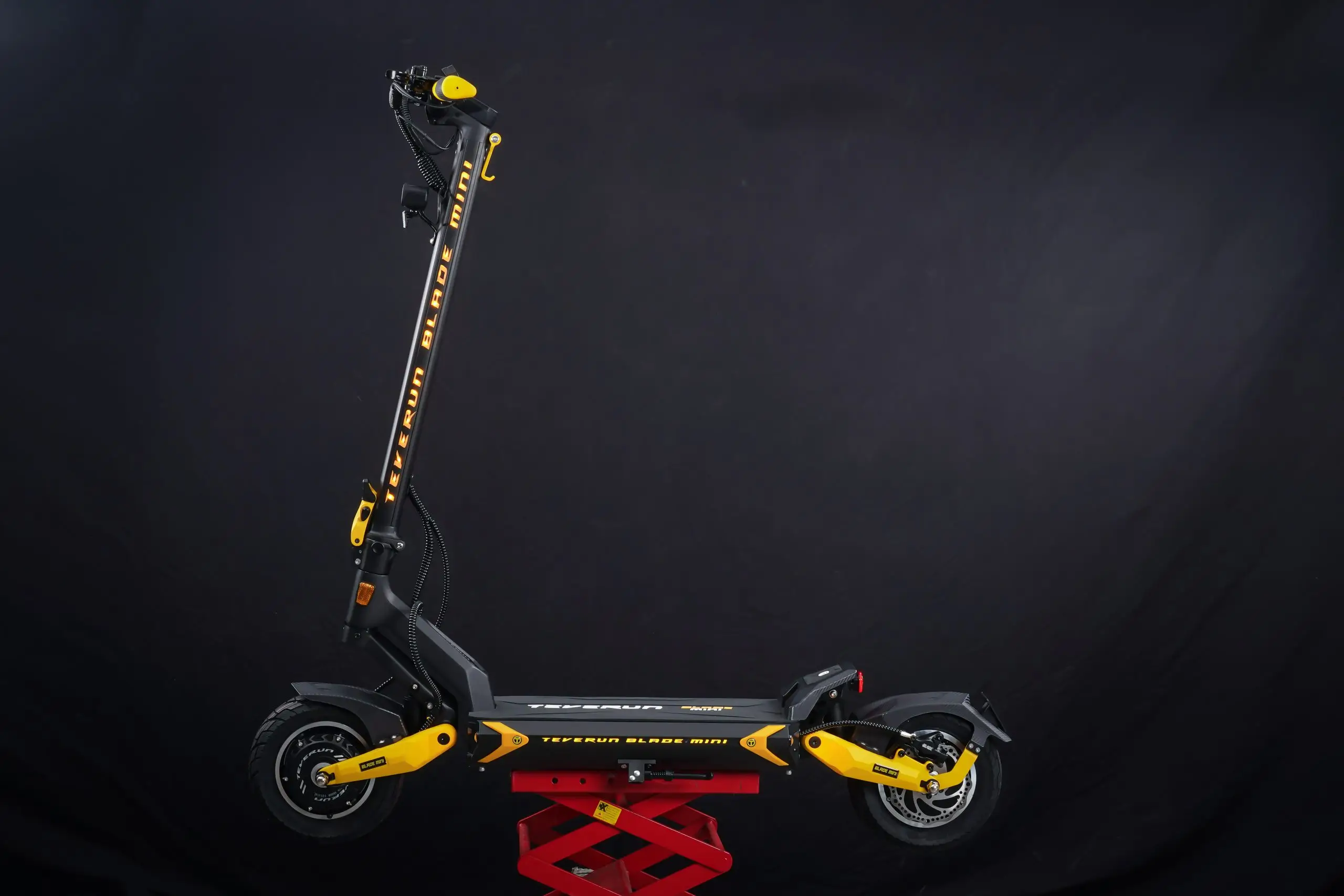 Teverun Blade Mini Ultra electric scooter fully lit on a black background