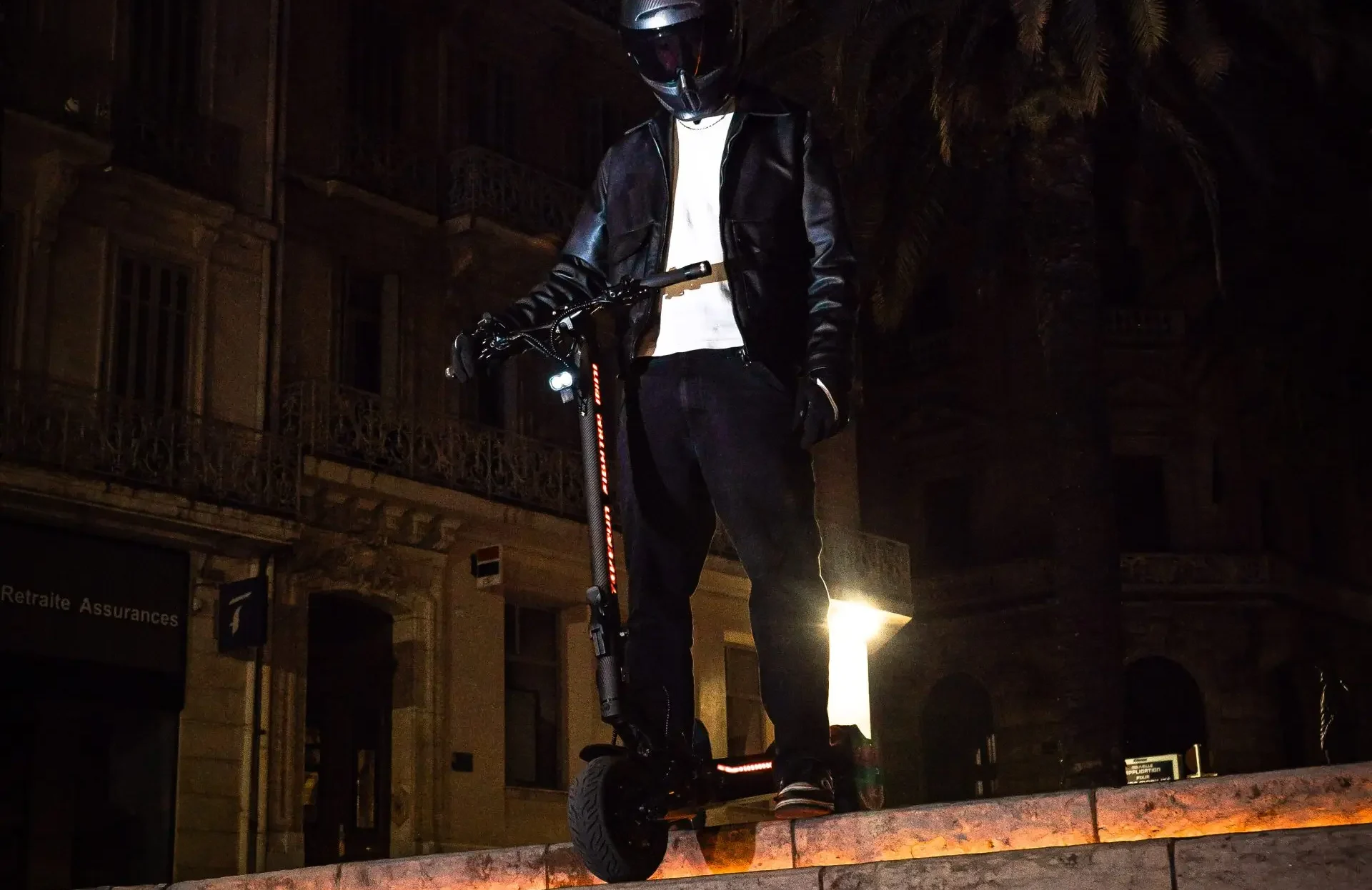 Rider on the Teverun Fighter Mini Pro electric scooter at night with the deck lighting on