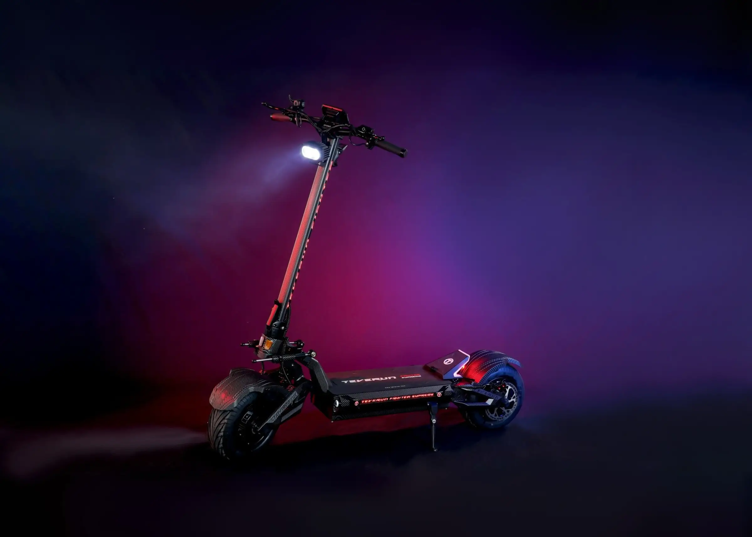 Teverun Fighter Supreme 7260R electric scooter lit in red and violet on a black background