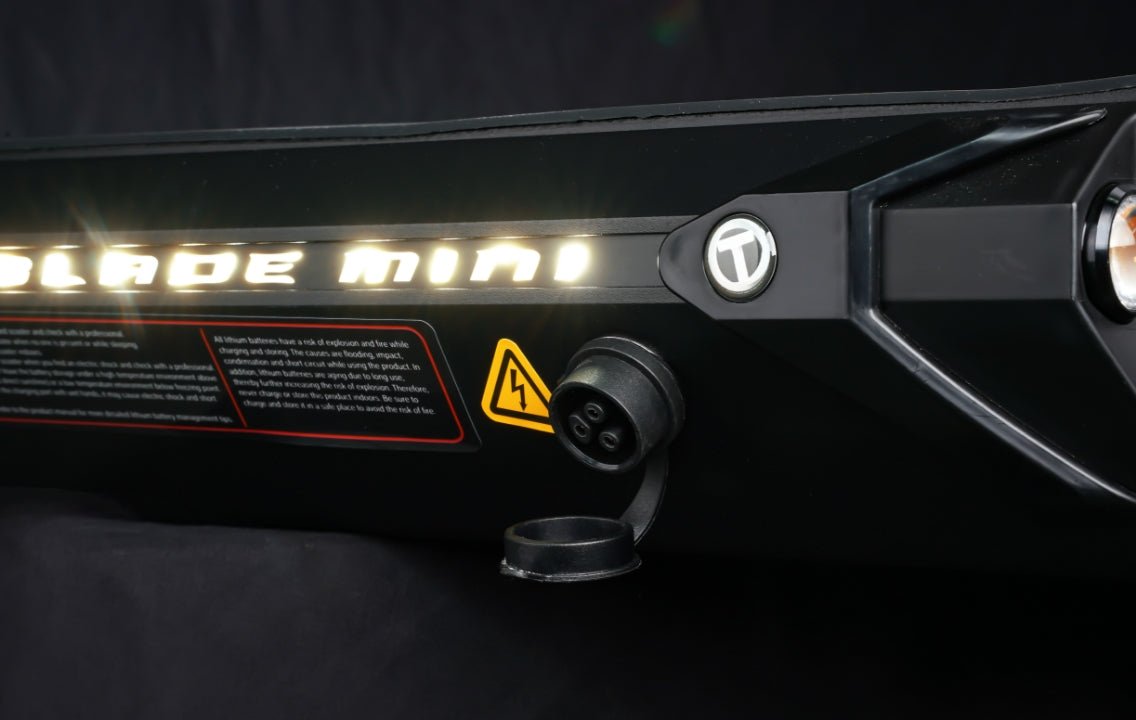 Illuminated Blade Mini lettering and charging port on the Teverun Blade Mini Pro electric scooter