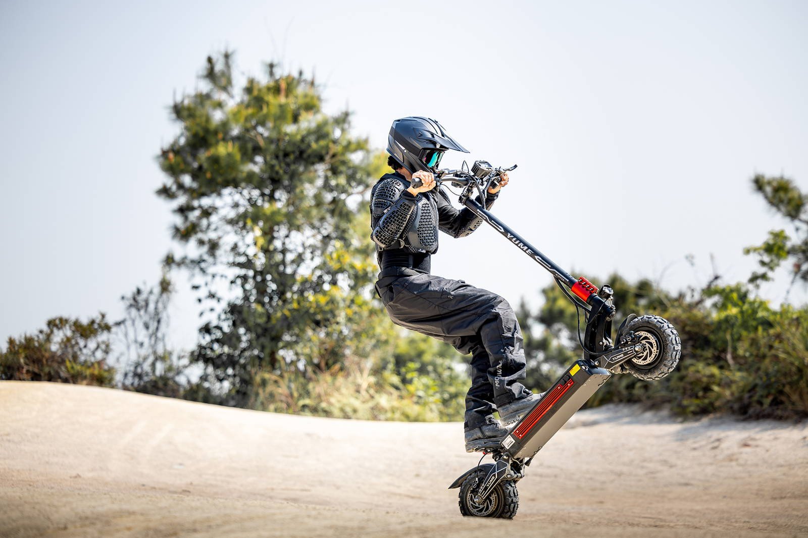YUME Raptor electric scooter rider on a gravel trail
